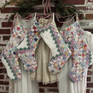Postage stamp quilt made into vintage Christmas stockings