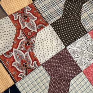 Colorful patchwork quilt top with various patterns.