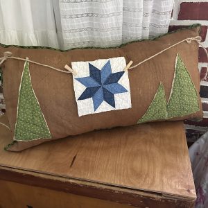 vintage cabin quilt pillow with blue star